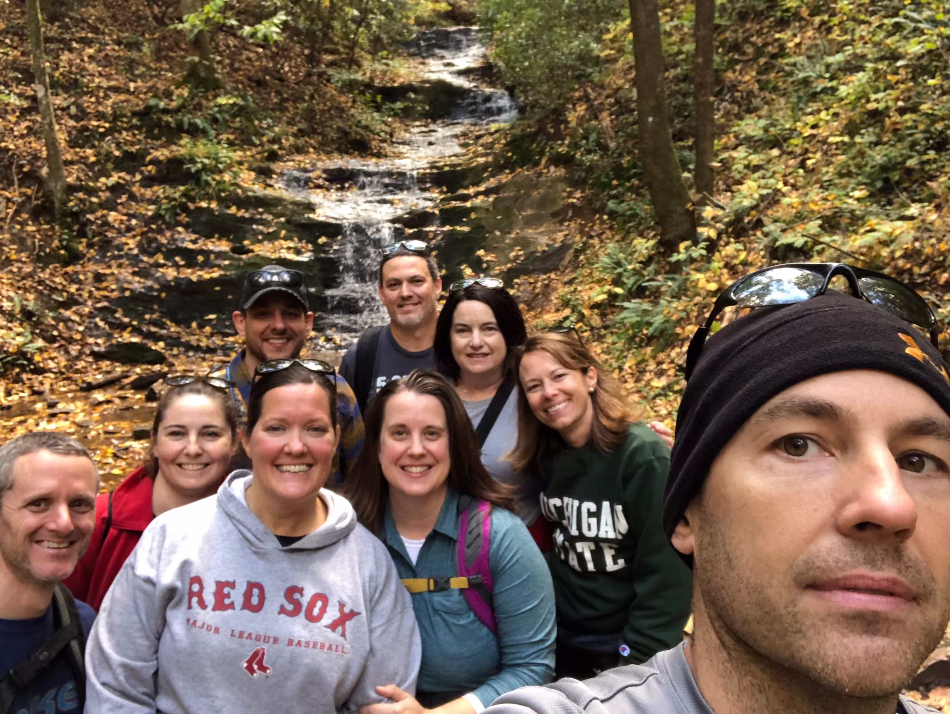Friends hiking a mountain trail together in North Carolina