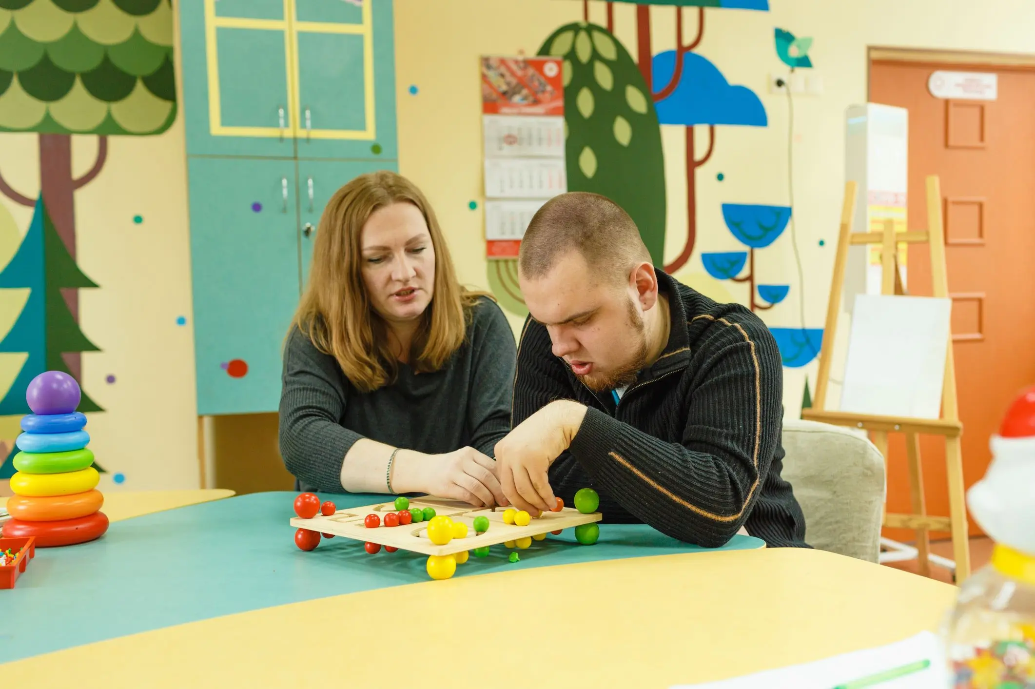 Parent and adult child with special needs reviewing documents together